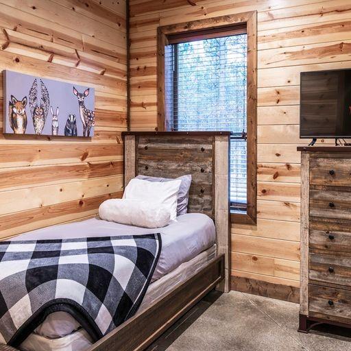 312 Sugar Pine Loop, Broken Bow, OK 74728 - bedroom with wooden walls