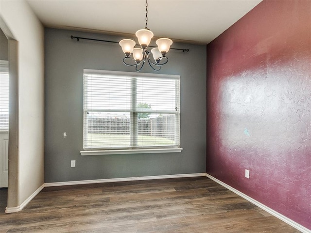 13309 Beaumont Dr, Piedmont, OK 73078 - unfurnished dining area with baseboards, an inviting chandelier, and wood finished floors