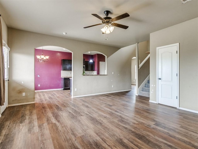 13309 Beaumont Dr, Piedmont, OK 73078 - unfurnished living room featuring stairs, baseboards, wood finished floors, and ceiling fan with notable chandelier