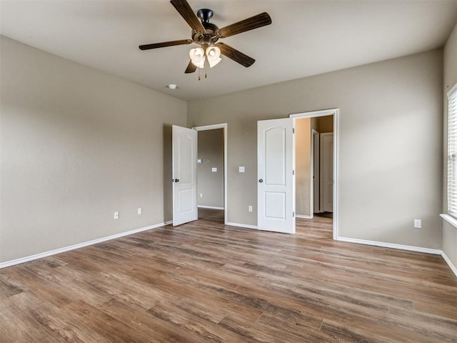 13309 Beaumont Dr, Piedmont, OK 73078 - unfurnished bedroom featuring baseboards, ceiling fan, and wood finished floors