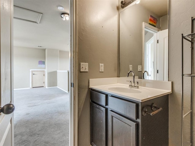 13309 Beaumont Dr, Piedmont, OK 73078 - bathroom featuring a textured wall, baseboards, and vanity