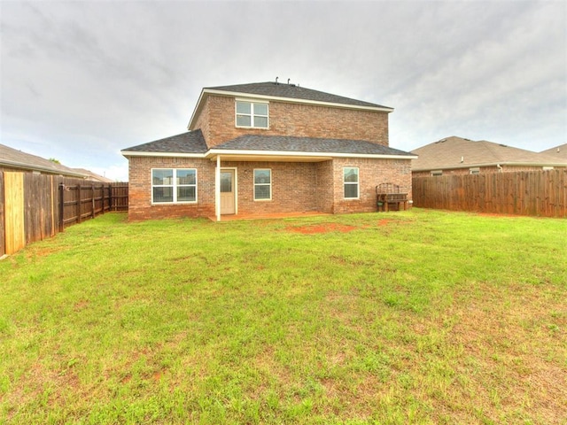 13309 Beaumont Dr, Piedmont, OK 73078 - back of house featuring a fenced backyard, a lawn, and brick siding