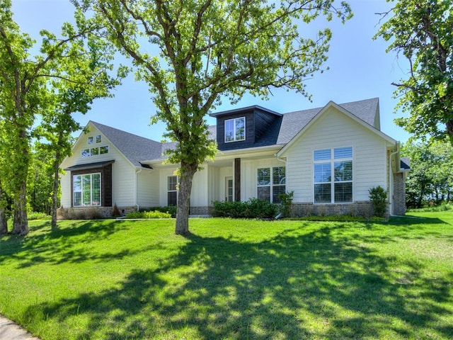 8241 Red Feather, Arcadia, OK 73007 - view of front of property with board and batten siding, a shingled roof, and a front lawn