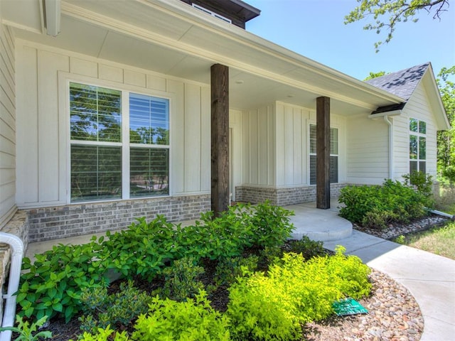 8241 Red Feather, Arcadia, OK 73007 - doorway to property with board and batten siding and a porch