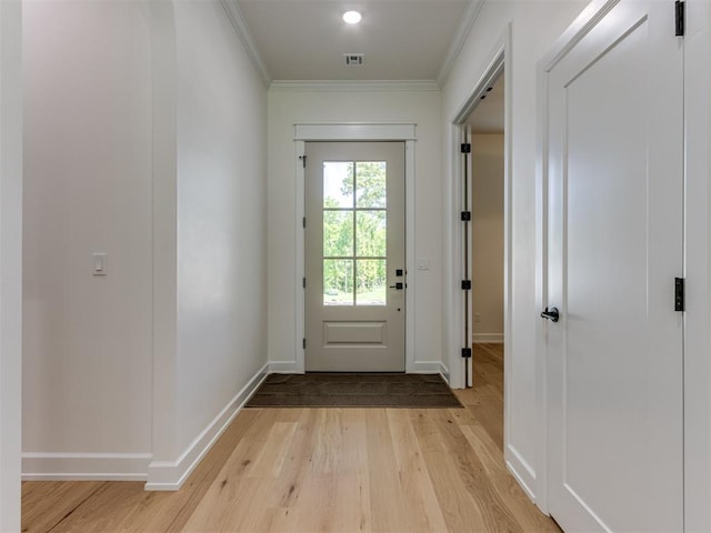 8241 Red Feather, Arcadia, OK 73007 - doorway to outside with baseboards, visible vents, ornamental molding, and light wood-style flooring