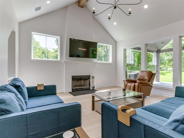 8241 Red Feather, Arcadia, OK 73007 - living area featuring high vaulted ceiling, visible vents, a wealth of natural light, and light wood-style floors