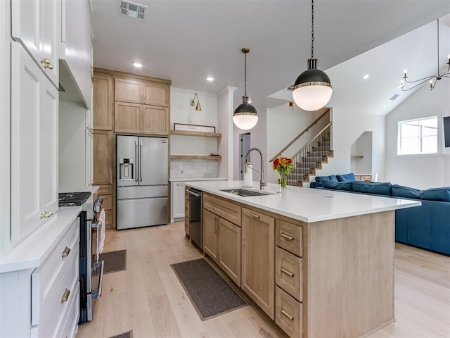 8241 Red Feather, Arcadia, OK 73007 - kitchen featuring visible vents, open shelves, light wood-style floors, a sink, and appliances with stainless steel finishes
