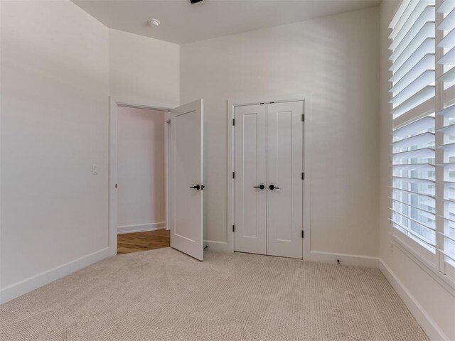 8241 Red Feather, Arcadia, OK 73007 - unfurnished bedroom with baseboards, light carpet, and a closet