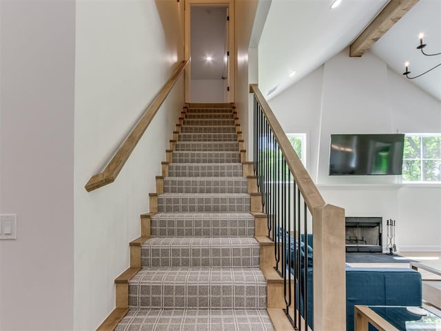 8241 Red Feather, Arcadia, OK 73007 - stairway with a fireplace, high vaulted ceiling, and beamed ceiling