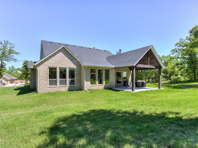 8241 Red Feather, Arcadia, OK 73007 - back of house featuring a yard, a patio, brick siding, and roof with shingles