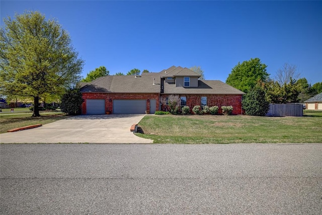 traditional-style house with an attached garage, driveway, fence, and a front yard