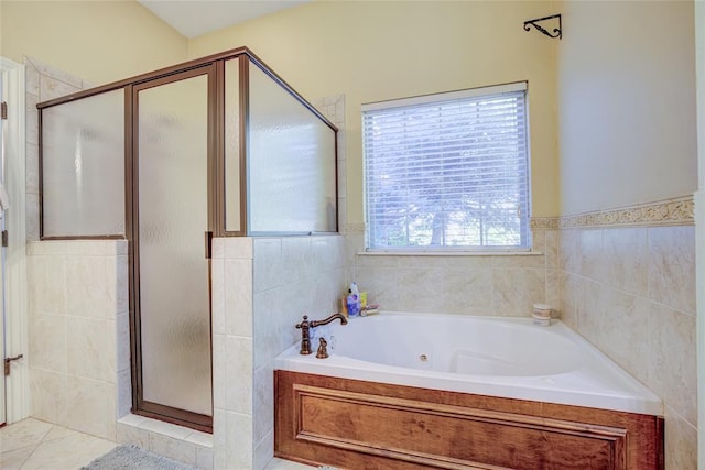bathroom with a jetted tub and a stall shower