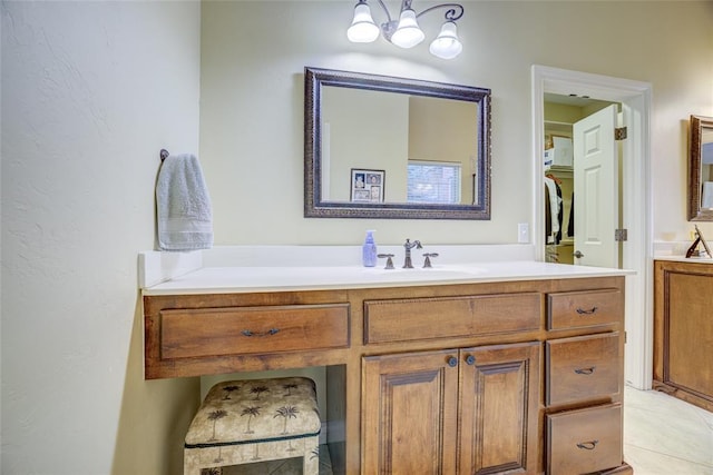 bathroom with a notable chandelier and vanity