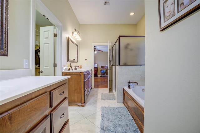 full bath featuring a shower stall, tile patterned floors, a bath, two vanities, and visible vents