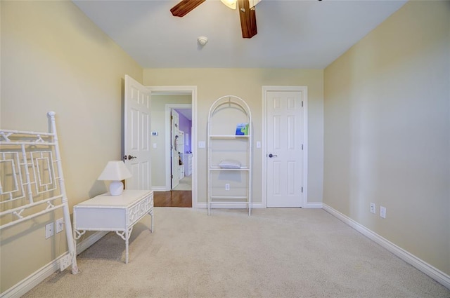 sitting room with carpet floors, baseboards, and ceiling fan