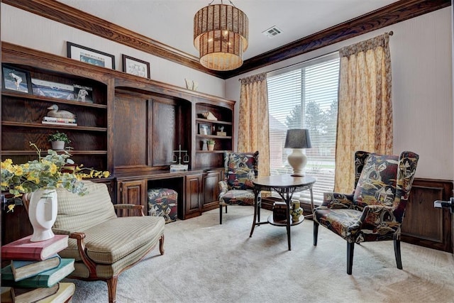 sitting room with visible vents, ornamental molding, a notable chandelier, and light carpet