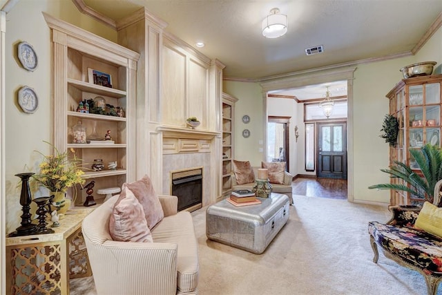 living room featuring visible vents, crown molding, baseboards, light colored carpet, and a high end fireplace