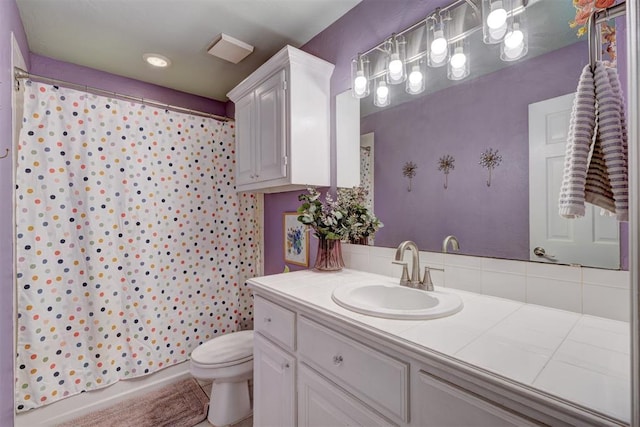 bathroom with vanity, toilet, and a shower with shower curtain