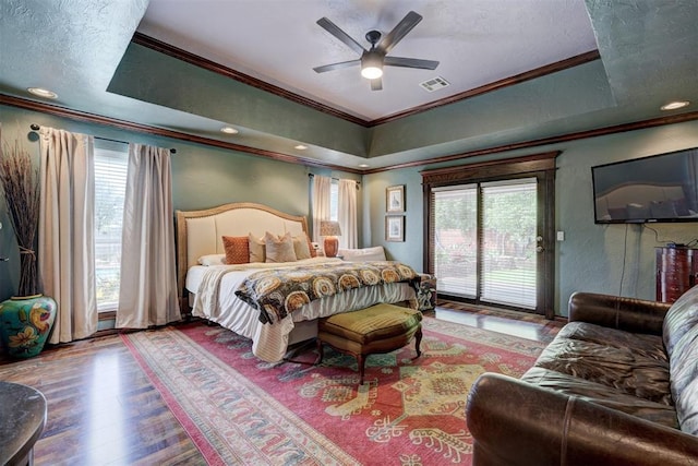 bedroom featuring visible vents, multiple windows, ornamental molding, and access to exterior