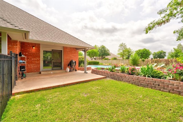 view of yard with a patio, a fenced in pool, and a fenced backyard