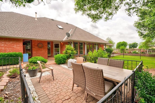 view of patio featuring outdoor dining area and fence