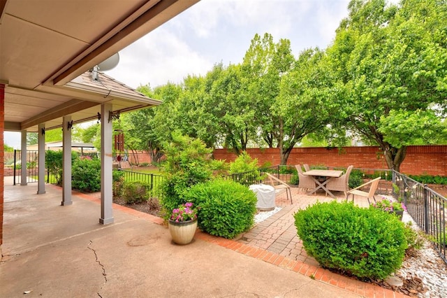 view of patio featuring a fenced backyard and outdoor dining area