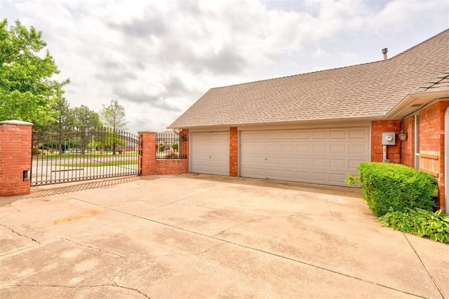 garage with a gate and fence