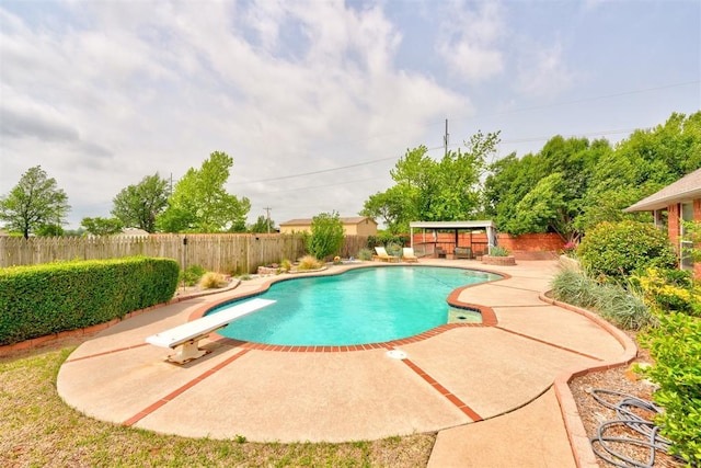 view of swimming pool featuring a patio, a fenced in pool, and a fenced backyard
