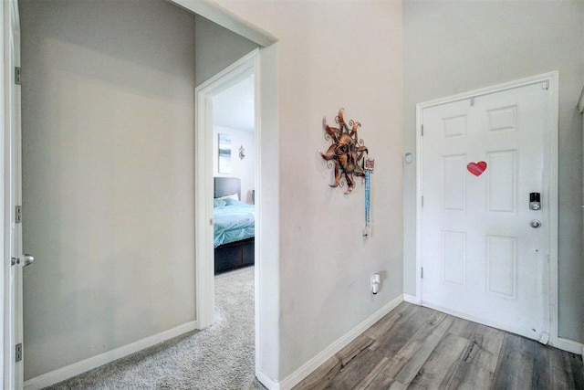 entryway with baseboards and wood finished floors