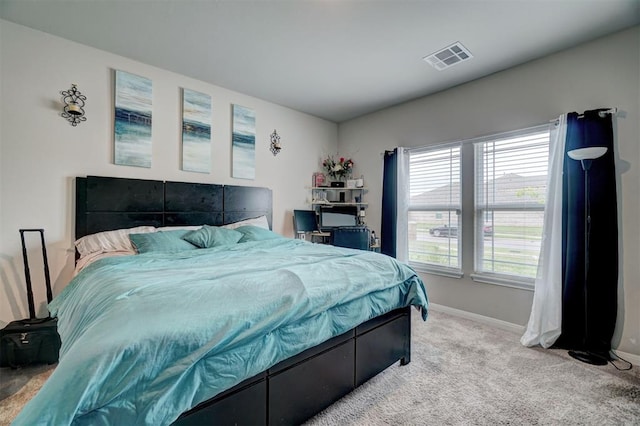 bedroom with carpet floors, baseboards, and visible vents