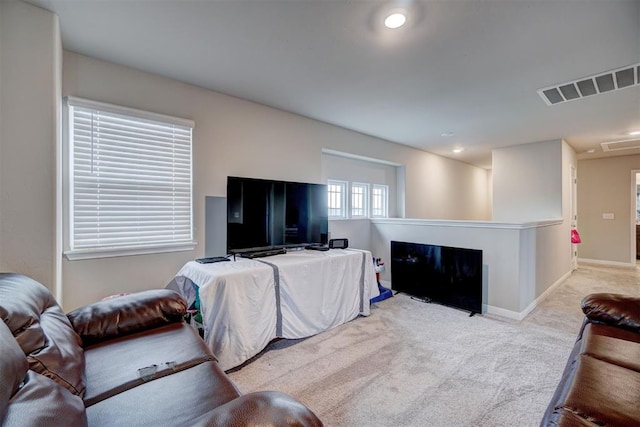 living area with carpet flooring, recessed lighting, baseboards, and visible vents