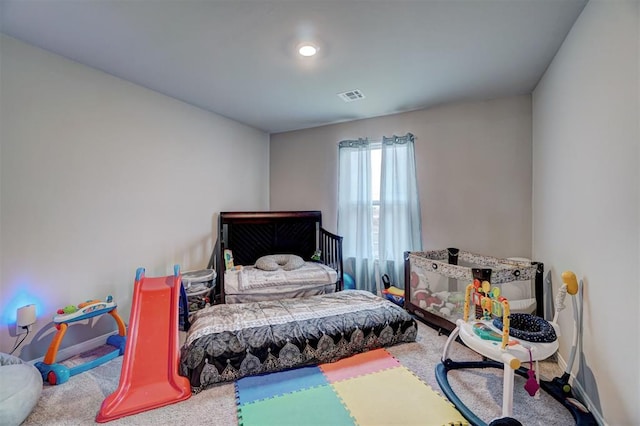 bedroom featuring baseboards, carpet, and visible vents