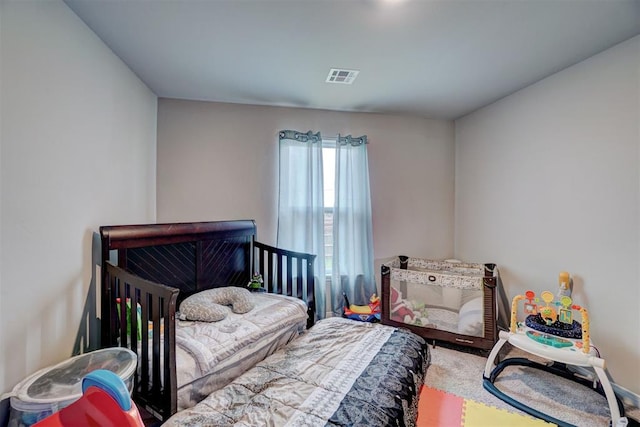 bedroom featuring visible vents and carpet