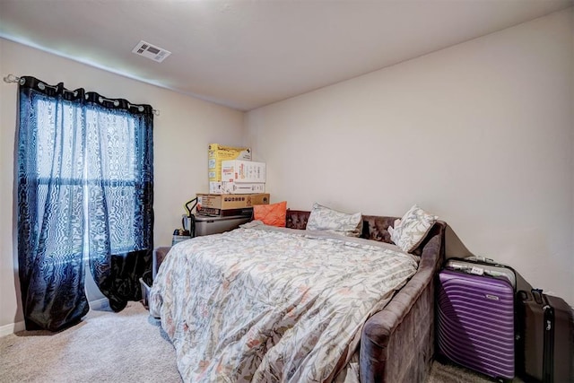 carpeted bedroom featuring visible vents