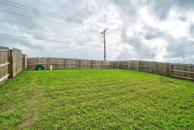 view of yard with a fenced backyard