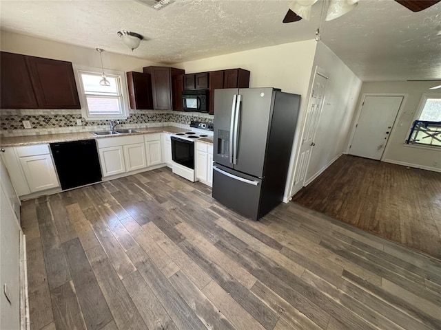 6718 NW 29th St, Bethany, OK 73008 - kitchen with black appliances, ceiling fan, dark wood-type flooring, light countertops, and a textured ceiling