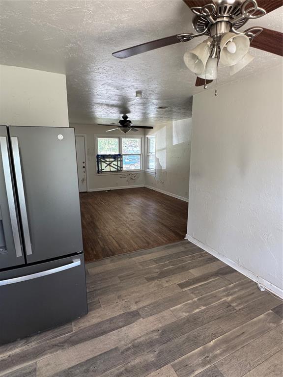 6718 NW 29th St, Bethany, OK 73008 - unfurnished room featuring ceiling fan, wood finished floors, and a textured ceiling