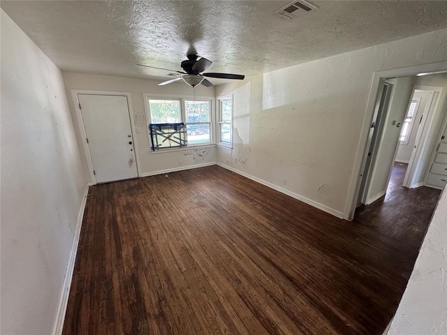 6718 NW 29th St, Bethany, OK 73008 - unfurnished living room featuring dark wood-type flooring, ceiling fan, and a textured ceiling