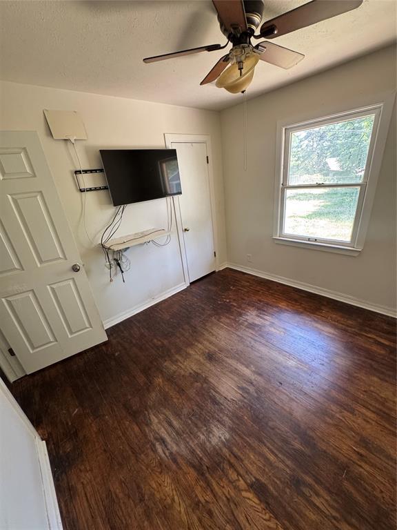 6718 NW 29th St, Bethany, OK 73008 - unfurnished bedroom with wood finished floors and a ceiling fan