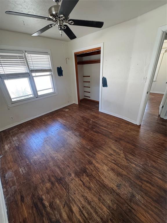 6718 NW 29th St, Bethany, OK 73008 - unfurnished bedroom featuring wood finished floors, ceiling fan, and a closet