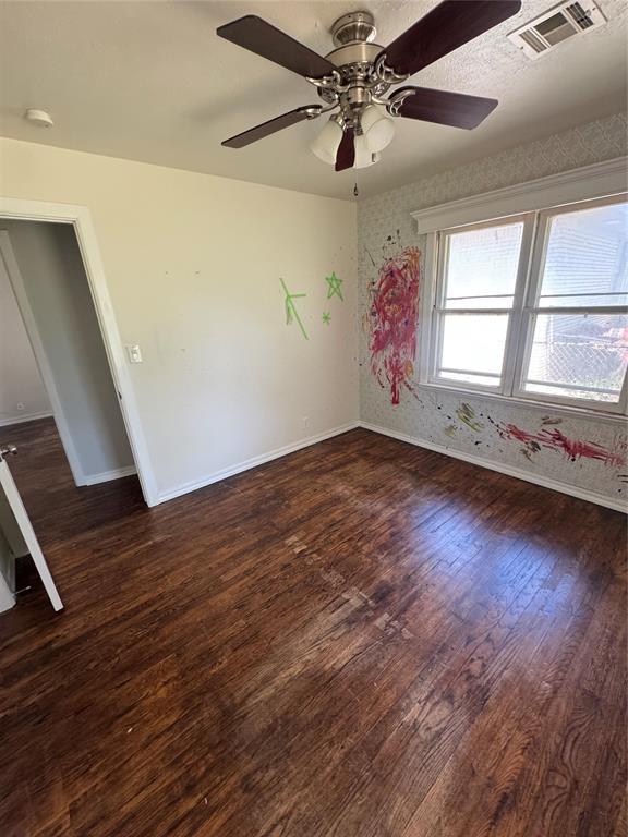6718 NW 29th St, Bethany, OK 73008 - empty room with wood finished floors, a smoke detector, and ceiling fan