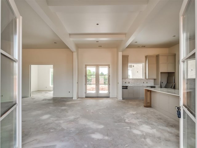 kitchen with french doors, tasteful backsplash, open floor plan, concrete flooring, and gray cabinets
