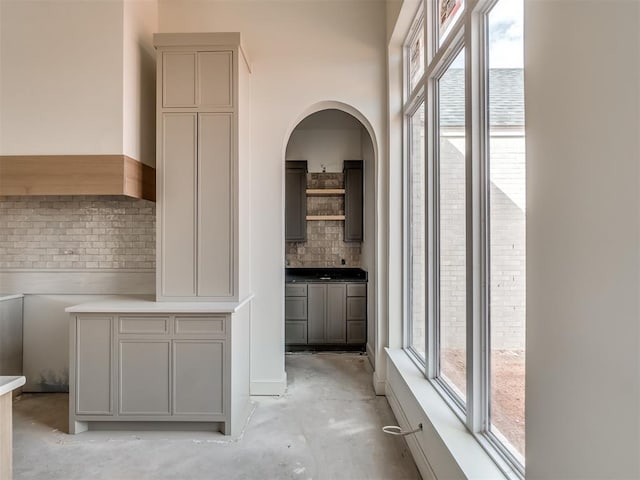 interior space with plenty of natural light, concrete flooring, and arched walkways