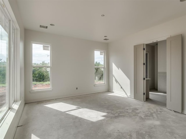 unfurnished bedroom featuring unfinished concrete floors and visible vents
