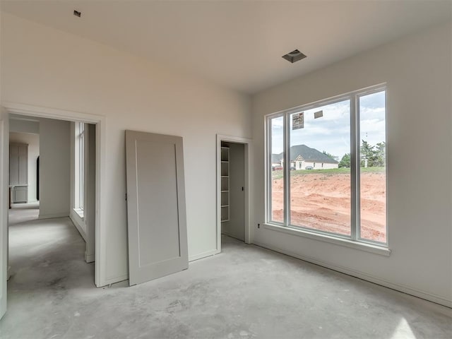 unfurnished bedroom featuring concrete floors