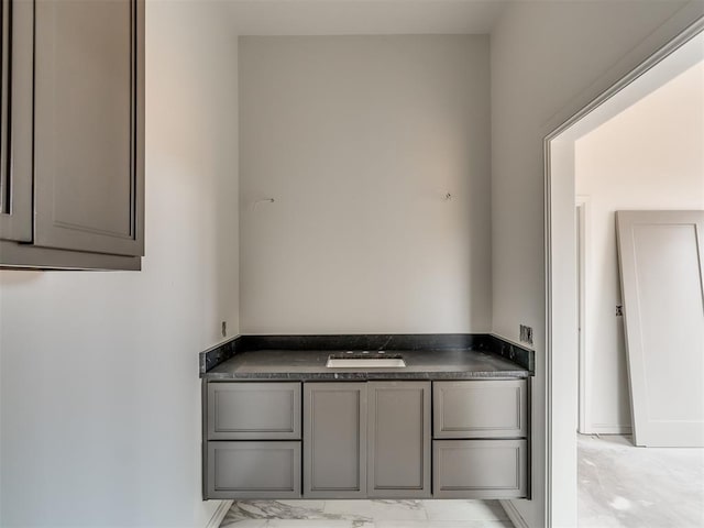 bathroom with marble finish floor and baseboards