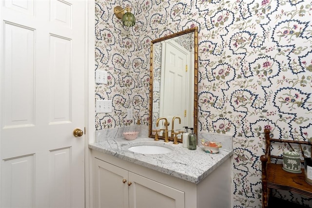 bathroom featuring vanity and wallpapered walls