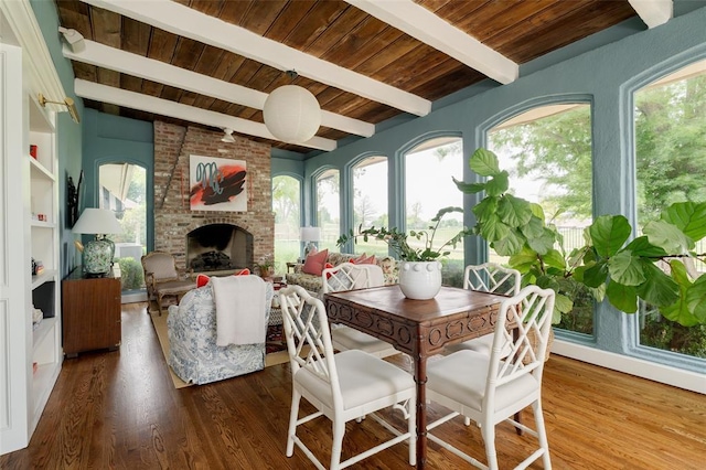 interior space with a healthy amount of sunlight, wooden ceiling, beamed ceiling, and wood finished floors