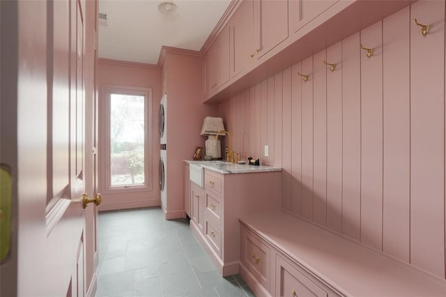mudroom with crown molding, light floors, and washer / dryer