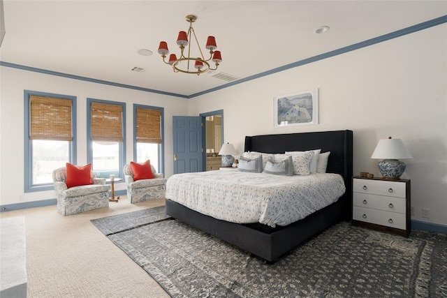 carpeted bedroom featuring visible vents, baseboards, and a chandelier